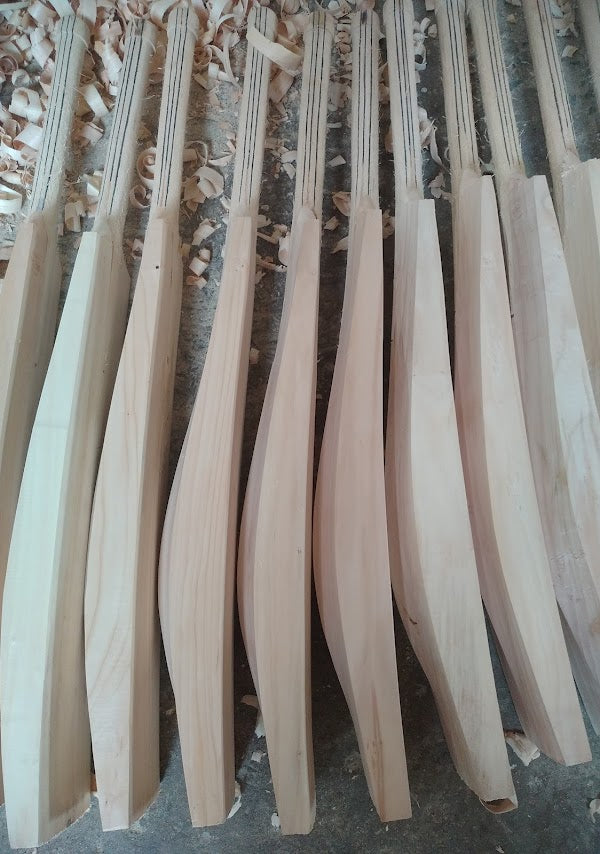 bunch of Cricket bats for leather ball, getting prepared to sell online. The bats are made of kashmir willow and have expensive cane handle added.